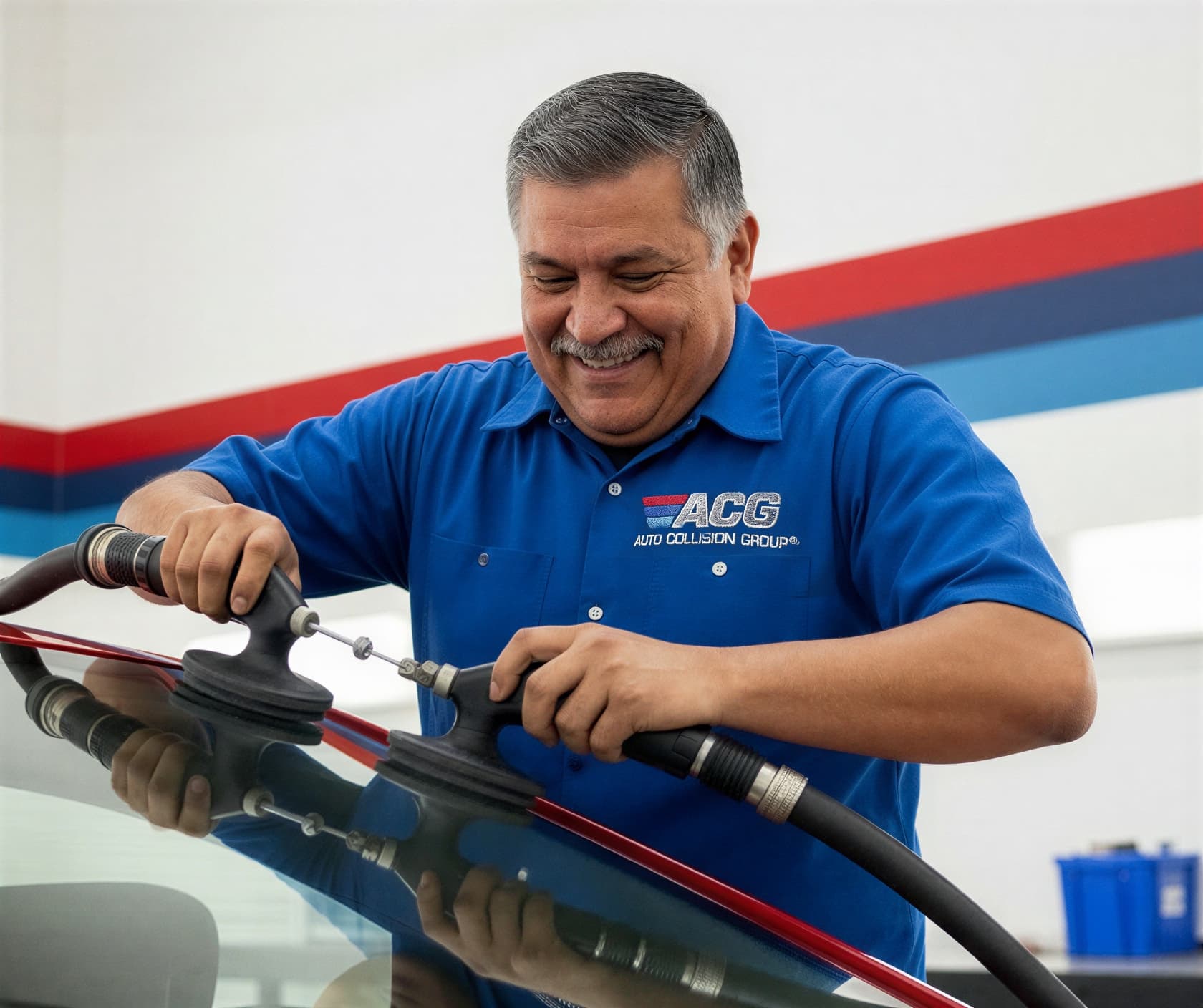Certified technician performing auto glass and windshield replacement at Auto Collision Group Bakersfield