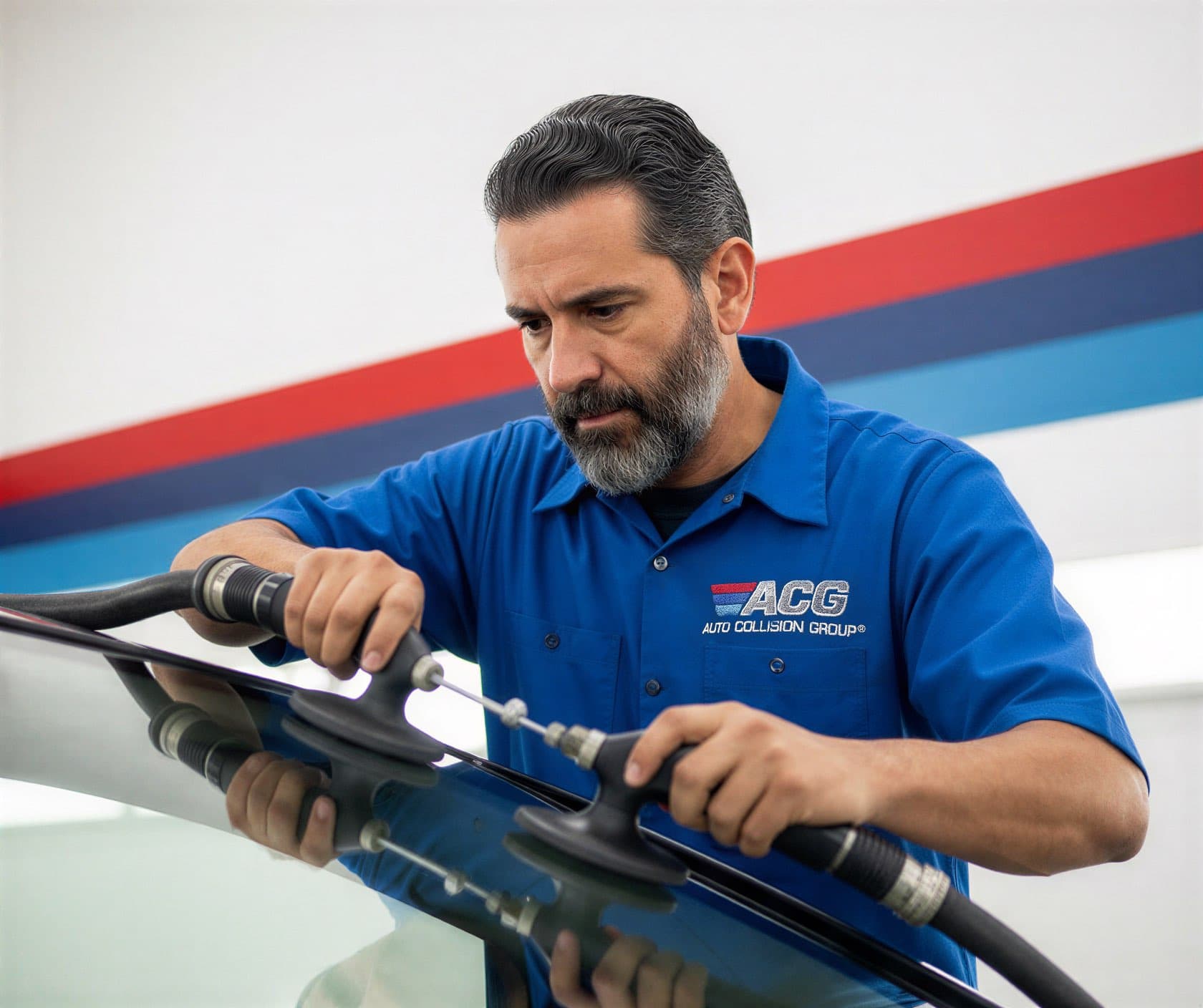 Certified technician performing auto glass and windshield replacement at Auto Collision Group Fresno