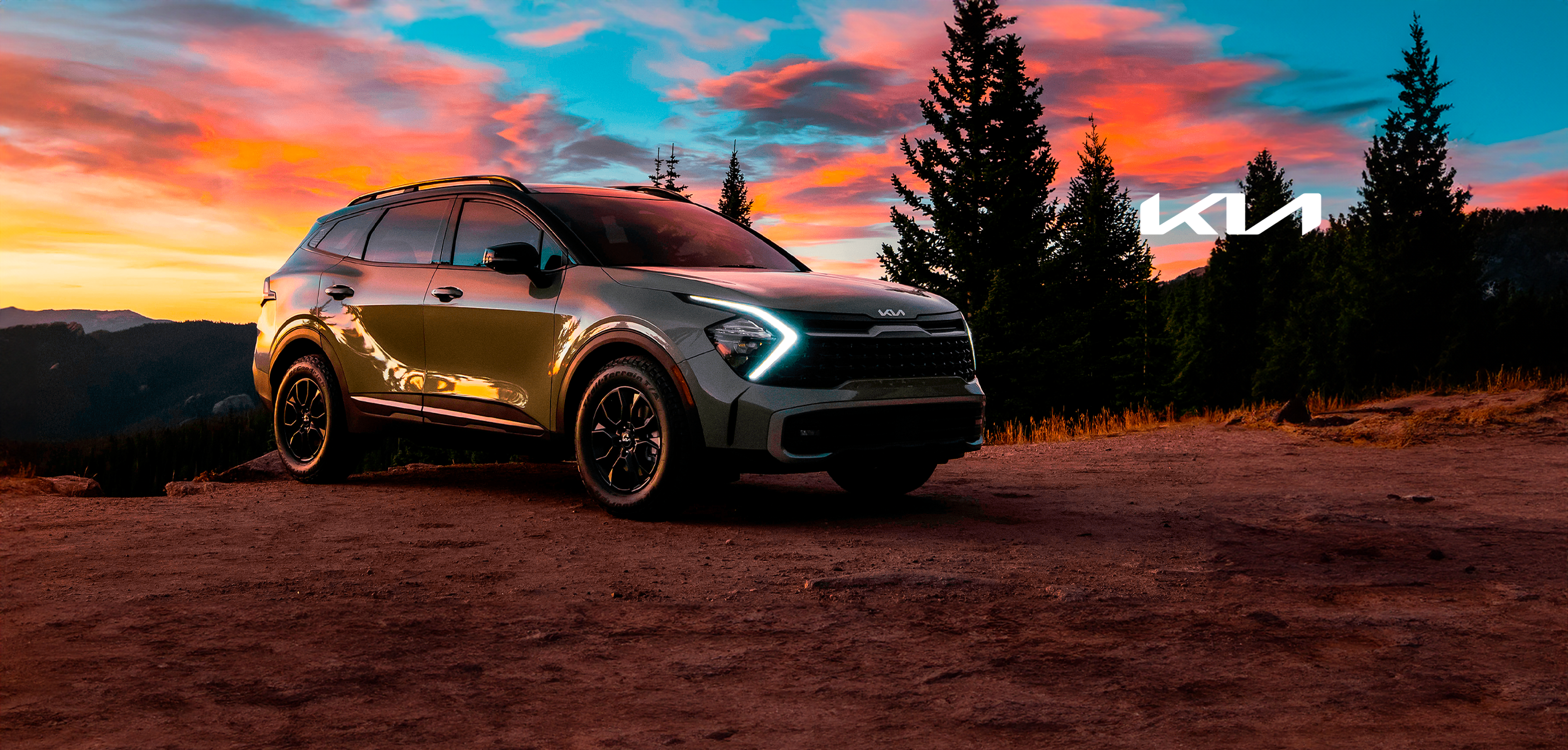SUV on scenic mountain sunset