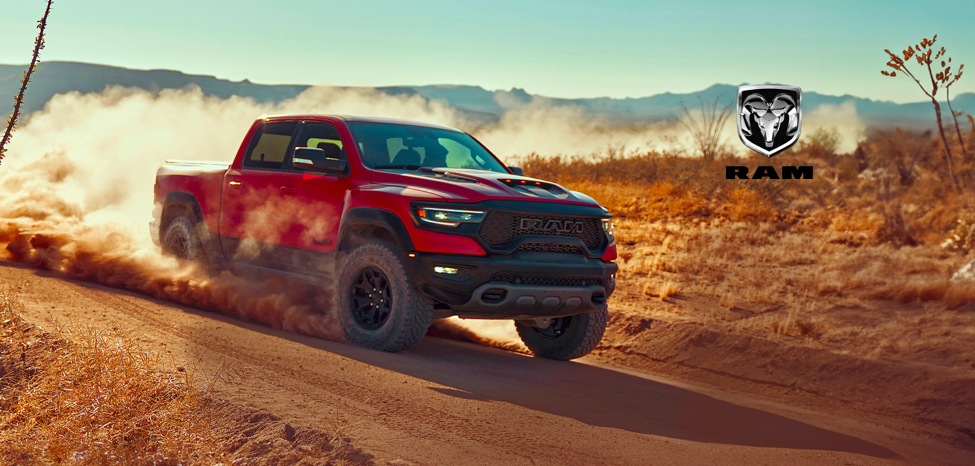 Red truck driving on dirt