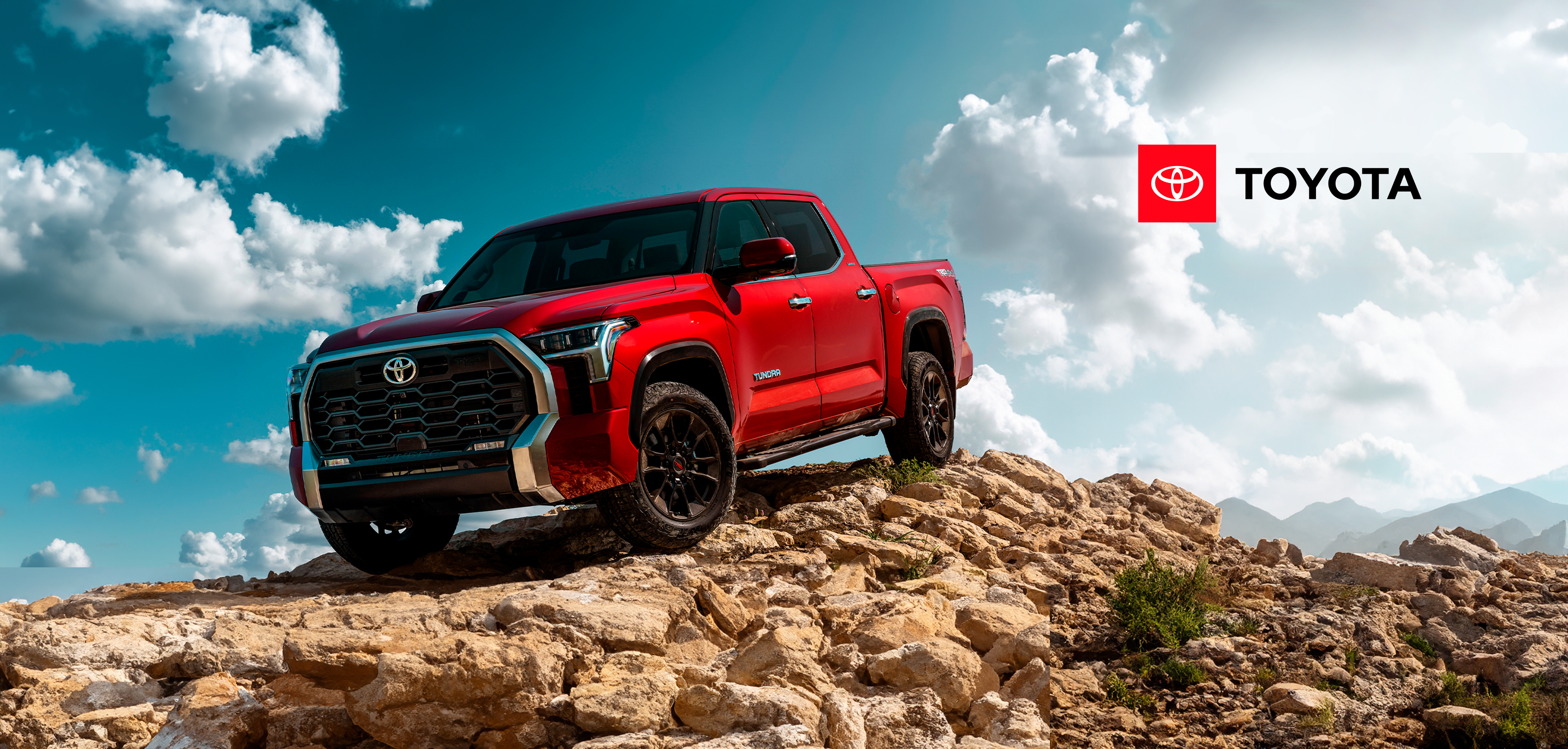 Red truck rocky terrain sky
