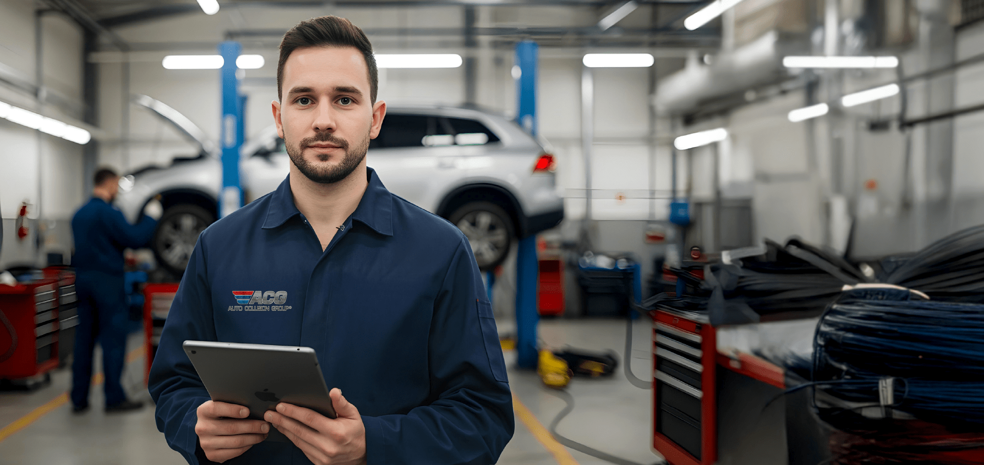 Mechanic using tablet in garage